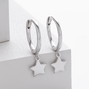 Close-up detail of silver S925 sterling silver star pendant hoop earrings on white block