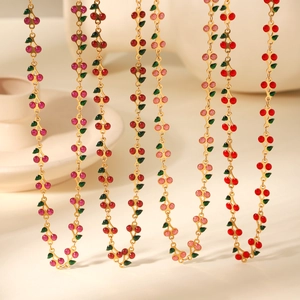 Detail view of cherry necklaces in red and pink glitter finish with gold chains