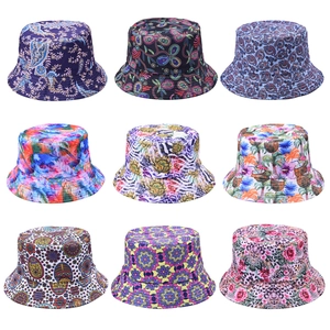 Multiple printed bucket hats featuring tropical, paisley, and leopard patterns for beach wear