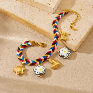 Handmade woven colorful cord bracelet with gold heart butterfly and ceramic flower charms