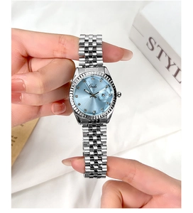 Dettaglio macro dell'orologio da donna argento con quadrante azzurro e lunetta zigrinata