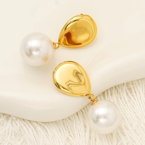 Elegant gold teardrop earrings with white pearl pendants in a vintage minimalist style