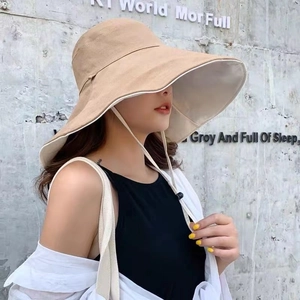 Women's wide brim khaki sun hat with adjustable windproof rope in a street style look