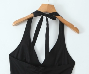 Detail view of deep V-neck halter dress with back zipper and tie fastening in black