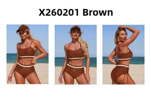 Detail view of coffee brown two-piece swimsuit with white stripes on beach background