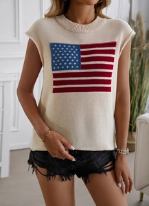 Macro detail of the woven American flag pattern on a beige knit sleeveless sweater vest
