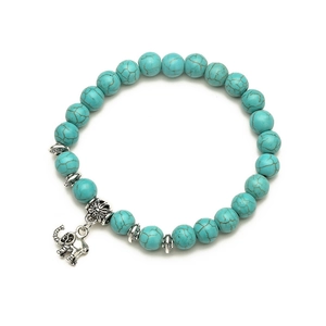 Bohemian turquoise beaded bracelet featuring a silver elephant charm on a white background