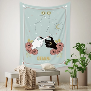 Close-up of Gemini zodiac tapestry with mint green base and pink floral illustrations