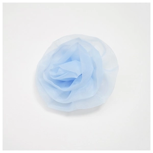 Detail of light blue mesh fabric rose brooch with multi-layered 3D floral petals