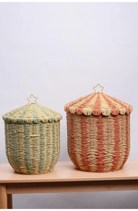 Detail of woven storage baskets with star metal handles and colorful fiber textures