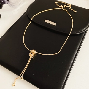 Close-up of golden circle pendant with sparkling zircons and delicate heart charms