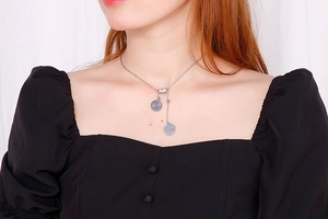Silver Y-necklace with engraved family silhouette pendants shown on a model