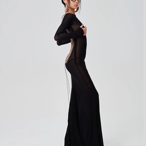 Detail of sexy backless lace-up design with metal eyelets on black mesh maxi dress