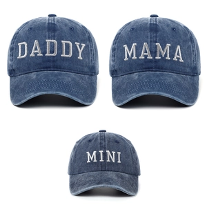 Detail of embroidered Daddy Mama Mini lettering on washed blue vintage baseball caps