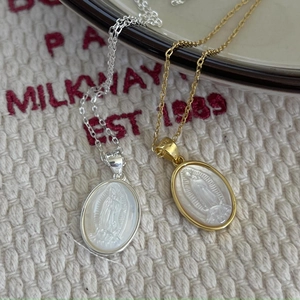 Close-up of gold and silver S925 sterling silver Virgin Mary necklaces with shell inlay