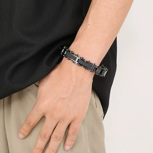 Close-up of industrial style black titanium steel chain bracelet on male wrist