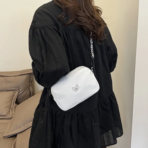 White butterfly crossbody bag with stylish wide nylon lettered strap on model