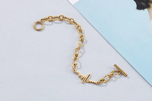 Detailed close-up of golden metal lifeline link bracelet with toggle clasp closure