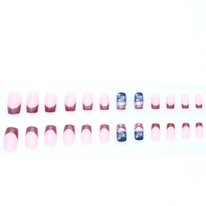 Short square press-on nails featuring red glitter French tips and blue star accents