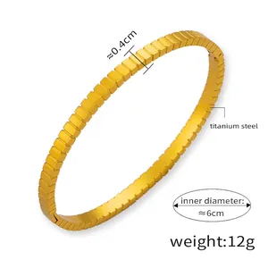 Detail view of 18k gold plated titanium steel bangle with 6cm diameter and 0.4cm width