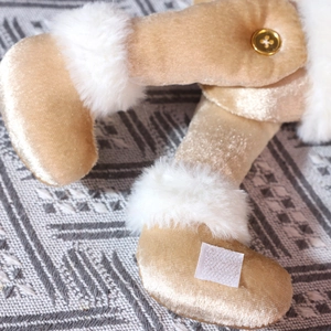 Macro shot of champagne velvet fabric with faux fur trim on a Christmas curtain tieback