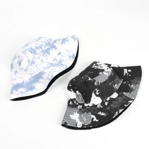 Close-up of cotton tie-dye bucket hats featuring reinforced stitched brims and canvas texture