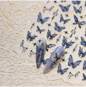 Detail of blue and purple butterfly nail stickers with holographic shimmer effects