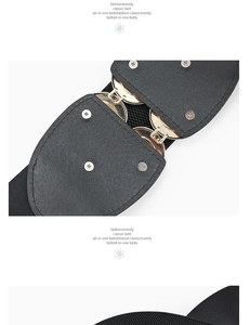 Detail of a vintage elastic wide belt featuring a textured gold metal buckle and rivets