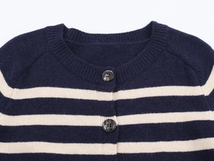 Detailed view of the round neck and buttons on a navy blue and white striped cardigan