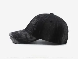Detailed side view of washed black distressed denim baseball cap with ripped details