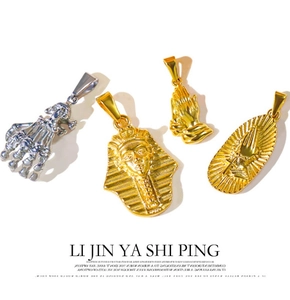 Detailed close-up of a vintage golden stainless steel Egyptian pharaoh and skull pendant