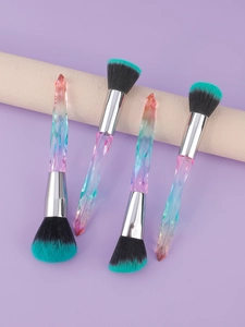 Detail of four colorful gradient crystal handle makeup brushes with soft dual-tone bristles
