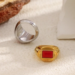 Vintage 18K gold plated stainless steel ring with rectangular red stone on stone background