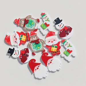 Flat lay of colorful Christmas acrylic charms featuring Santa and snowman for DIY jewelry