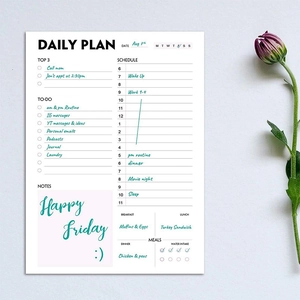 Flat lay of a daily planner notepad featuring schedule, to-do list, and meal tracking