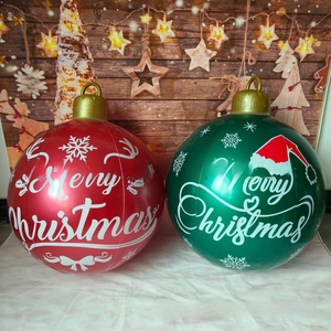 Detail view of large red and green inflatable Christmas balls with Merry Christmas patterns
