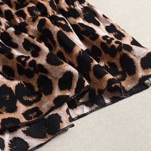 Detailed view of leopard print fabric featuring layered ruffles and high-quality stitching