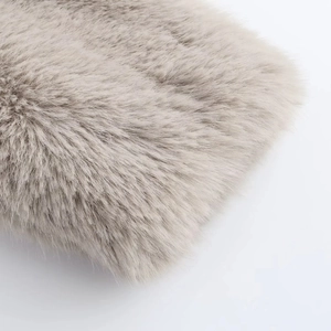 Close-up detail of soft faux fur texture on a warm taupe street style winter coat