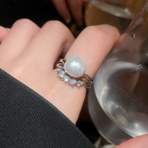 Detail of elegant silver ring with a large white pearl and sparkling pavé diamonds