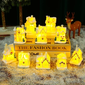 Luminous Christmas village resin houses with warm LED lights and snowy scene decor