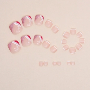 Pink glitter French press-on toenails with white star patterns and sparkling finish
