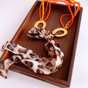 Bohemian multilayer beaded necklace with leopard print silk bow and gold textured rings