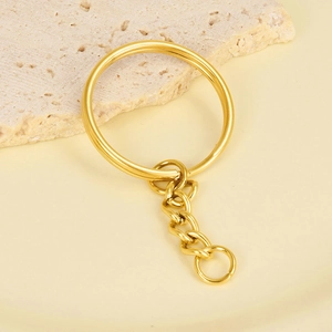 Detail view of 18K gold plated stainless steel key ring with short chain on stone