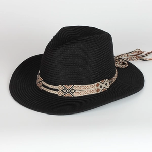 Black straw fedora sun hat with bohemian geometric ribbon and tassel on white background