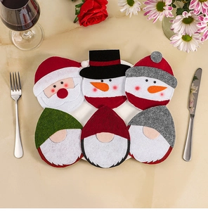Detail of six Christmas cutlery holders including Santa and Gnomes on a festive dinner plate