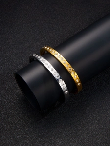 Close-up of gold and silver titanium steel bangles with rhombic diamond-set detailing