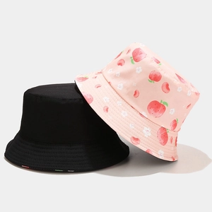 Reversible bucket hat in black and pink peach print for summer sun protection