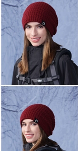 Détail d'un bonnet en tricot rouge foncé avec texture côtelée et logo sur le côté
