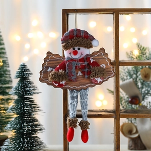 Detail of a Christmas snowman ornament with a wooden cloud plaque and knitted plaid hat