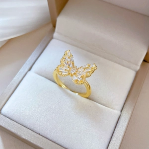 Exquisite gold-plated butterfly ring with sparkling zircon inlays on a light jewelry box